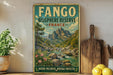 a vintage-style sign for the Fango Biosphere Reserve in France, with a scenic mountain landscape and a river. The sign is displayed on a shelf next to a wooden cutting board and some potted plants.