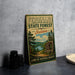 A vintage-style metal sign for Ferdinand State Forest, Indiana, featuring a scenic landscape with pine trees, a lake, and a sign that says "Explore Hike Relax Enjoy".