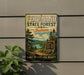 A vintage-style sign for the Ferdinand State Forest in Indiana, featuring a scenic landscape with pine trees, a lake, and a sign inviting visitors to explore, relax, and enjoy the natural beauty of the area.