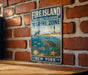 A vintage metal sign for the Fire Island National Seashore Marine Zone in New York, featuring illustrations of marine life such as a dolphin, turtle, and starfish.