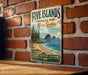 a vintage-style metal sign for Five Islands Provincial Park in Nova Scotia, Canada, mounted on a brick wall.