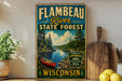 A vintage-style metal sign for Flambéau River State Forest in Wisconsin, featuring a canoe and a scenic landscape.
