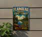 A vintage-style metal sign for Flambéau River State Forest in Wisconsin, featuring a scenic illustration of a lake, forest, and canoe.