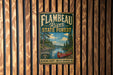A vintage-style metal sign for the Flambéau River State Forest in Wisconsin, featuring a canoe and a scenic landscape.