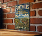 A vintage-style metal sign for the Flint Hills National Wildlife Refuge in Kansas, featuring an illustration of a bird and a scenic landscape.