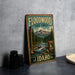 A vintage-style sign for the Floodwood State Forest in Idaho, featuring a scenic illustration of a forest and a river.
