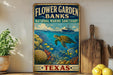 A vintage-style sign for the Flower Garden Banks National Marine Sanctuary in Texas, featuring an illustration of a turtle swimming among coral and fish in the ocean.