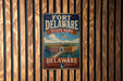 A vintage-style metal sign for Fort Delaware State Park, featuring an illustration of the fort and its surrounding landscape.