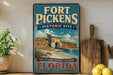 A vintage-style sign for the Fort Pickens Historic Site in Florida, featuring a picture of the fort and surrounding landscape.