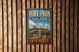 A vintage metal sign for Fort Union National Monument, featuring a cannon and a sign that says "A Place Where the Old Lives on".