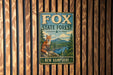 A vintage metal sign for Fox State Forest in New Hampshire, featuring an illustration of a fox in a forest setting.