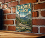 a vintage-style sign for Franconia Notch State Park, mounted on a brick wall.