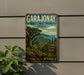 A vintage-style metal sign for the Garajonay National Park in Spain, featuring a lush tropical landscape with a winding path and a mountain backdrop.