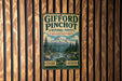 A vintage-style metal sign for Gifford Pinchot National Forest in Washington, featuring a mountain landscape and the words "Explore, Discover" in the center.