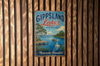 A vintage-style metal sign with the text "Gippsland Lakes" and "Australia" is displayed on a wooden wall.