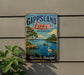 A vintage-style metal sign for Gippsland Lakes, Australia, featuring a scenic image of a lake, a boat, and a swan.