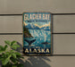 A vintage-style metal sign for Glacier Bay National Park in Alaska, featuring a scenic image of the waterfall and surrounding landscape.