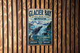 A vintage metal sign for Glacier Bay National Marine Preserve in Alaska, featuring an illustration of a whale and mountains.