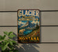 A vintage-style sign for Glacier Country, Montana, featuring a mountain landscape with a goat and a lake.