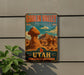 A vintage-style metal sign for Goblin Valley State Park, featuring a desert landscape with rock formations and mountains.
