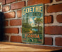 A vintage-style metal sign for Goethe State Forest in Florida, featuring a palm tree and a river, is displayed on a brick wall.