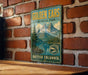 A vintage-style sign for Golden Ears Provincial Park in British Columbia, Canada, featuring a mountain landscape and a lake.