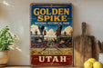 a vintage-style sign for Golden Spike National Historical Park in Utah, with a train illustration and text.