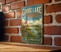 A vintage-style sign for Goose Lake Prairie, Illinois, featuring a scenic landscape with flowers and a lake.