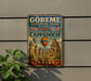 A vintage-style sign for the Görme National Park and the Rock Sites of Cappadocia, Turkey, featuring a colorful illustration of the rock formations and hot air balloons.