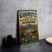 A vintage metal sign for the Gouritz Cluster Biosphere Reserve in South Africa, featuring an illustration of a mountain range, a river, and a gazelle.