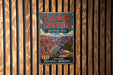 A vintage-style metal sign for the Grand Canyon National Park, featuring a scenic illustration of the canyon and the text "Grand Canyon National Park - American Natural Wonder".