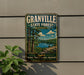 A vintage metal sign for Granville State Forest in Massachusetts, featuring a scenic landscape with a lake and forest.