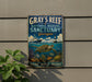 A vintage metal sign for the Gray's Reef National Marine Sanctuary in Georgia, featuring an illustration of a turtle swimming among coral and marine life.