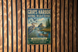 A vintage-style metal sign for the Grays Harbor National Wildlife Refuge in Washington, featuring a seagull and ducks in a grassy area with a mountain backdrop.