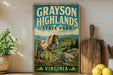 A vintage-style sign for Grayson Highlands State Park in Virginia, featuring a horse in a mountainous landscape.