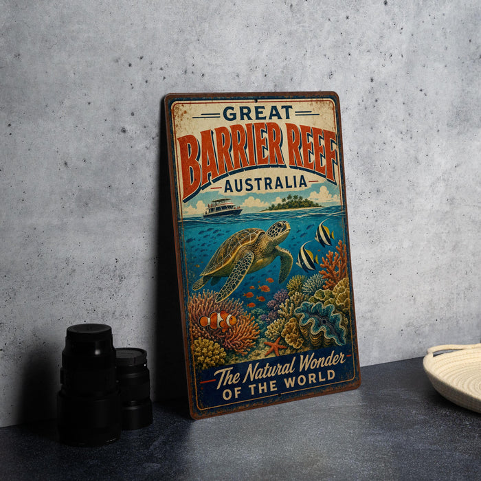 A vintage-style metal sign advertising the Barrier Reef in Australia, featuring an illustration of a sea turtle swimming among colorful coral and fish.