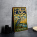 A vintage-style sign for Great Blue Heron Provincial Park in Saskatchewan, featuring a heron standing on a grassy bank with a lake in the background.