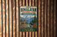 A vintage-style metal sign for the Great Himalayan National Park in India, featuring a mountain landscape with a goat and a peacock.