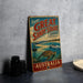 A vintage-style metal sign advertising "Great Sandy Strait" in Australia, featuring a scenic illustration of a beach, ocean, and wildlife.