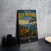 a vintage-style metal sign with a scenic mountain landscape, placed on a countertop next to some camera equipment.