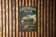 A vintage-style sign for the Green-Meldrim House in Georgia, featuring a large illustration of a historic two-story house with a wrap-around porch and a tower.