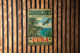 A vintage-style metal sign with a tropical beach scene and palm trees, advertising the Guianacabines Biosphere Reserve in Cuba.