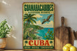 A vintage-style sign for the Guanahacibes Biosphere Reserve in Cuba, featuring a tropical landscape with palm trees, a bird, and a body of water.