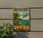 A vintage-style sign for the Guanahacibes Biosphere Reserve in Cuba, featuring a tropical landscape with palm trees, a bird, and a body of water.