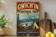 A vintage-style sign for GWICH'IN TERRITORIAL PARK, featuring a deer, a teepee, and a mountain landscape.