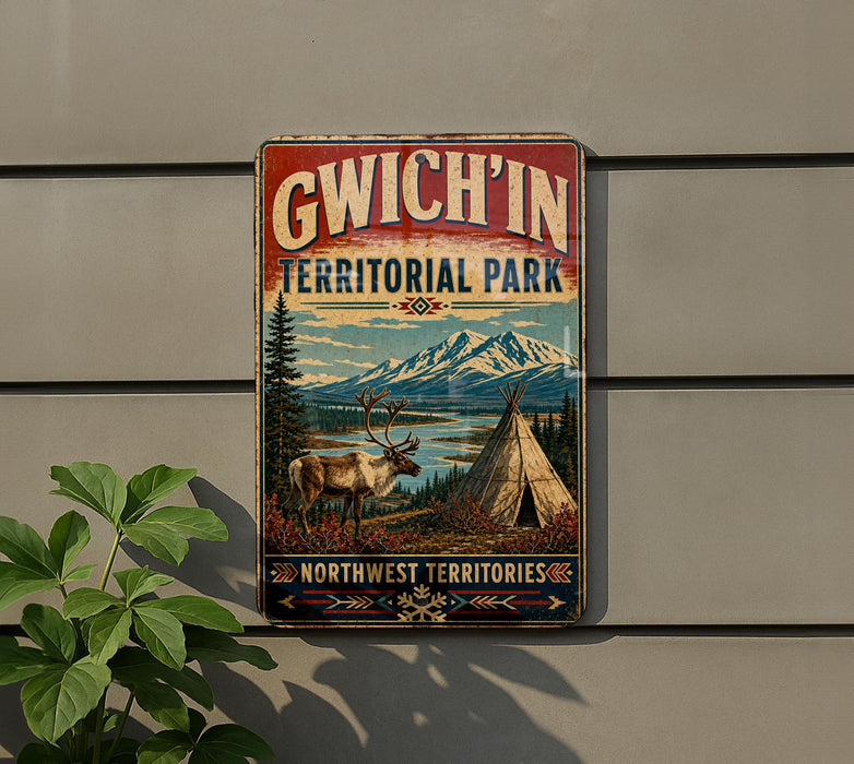 A vintage-style sign for GWICH'IN TERRITORIAL PARK, featuring a reindeer, a teepee, and a mountain landscape.