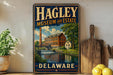 A vintage metal sign for the Hagley Museum and Estate in Delaware, featuring an illustration of a building with a waterfall and a bridge.