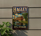 A vintage metal sign for the Hagley Museum and Estate in Delaware, featuring an illustration of a building and a waterfall.