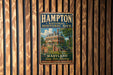 A vintage metal sign for the Hampton National Historic Site in Maryland, featuring an illustration of a historic house and cannon, mounted on a wooden wall.