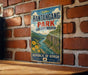 A vintage-style metal sign with the text "Explore Hantangang Park" and "Nature-History-Adventure" hangs on a brick wall.